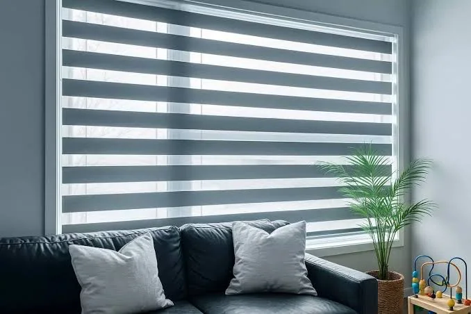 Modern grey zebra blinds across a wide window